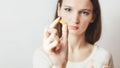 ÃÂaucasian woman holding in pill Close up . Sick female taking medicines, vitamin, antidepressant, painkiller or antibiotic. Royalty Free Stock Photo